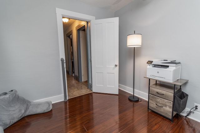 bedroom with dark hardwood / wood-style floors