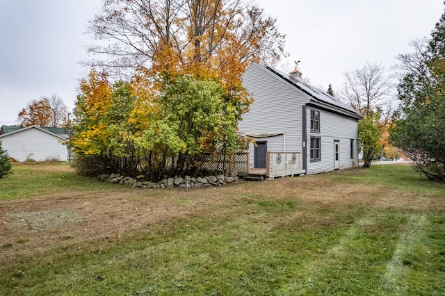 view of side of property with a lawn