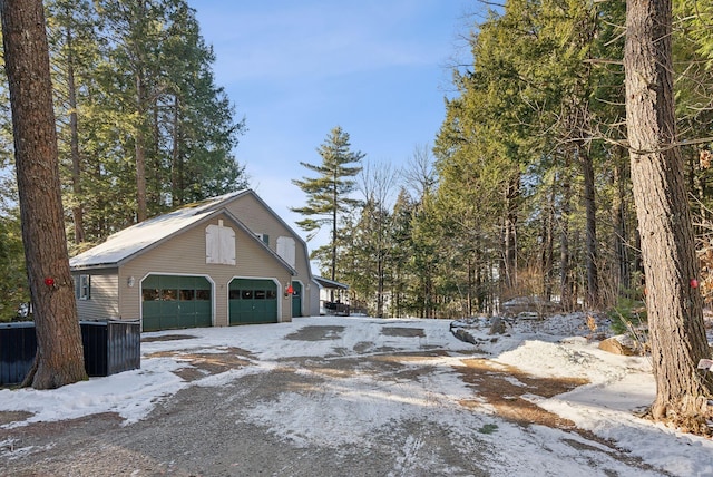 view of snowy exterior with a garage