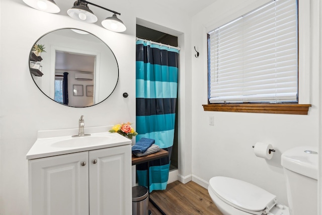 bathroom featuring hardwood / wood-style flooring, vanity, a wall mounted air conditioner, curtained shower, and toilet