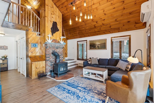 living room featuring wood ceiling, wood-type flooring, a wall mounted AC, a wood stove, and a baseboard radiator