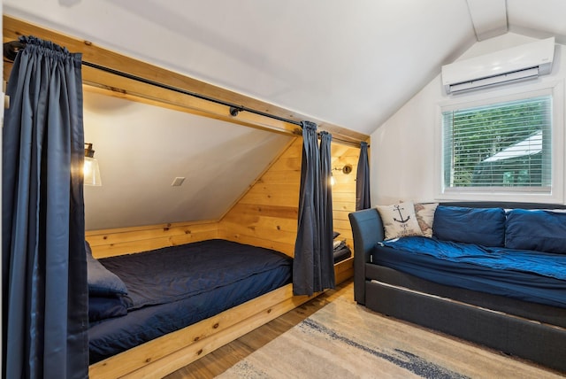 bedroom featuring vaulted ceiling, a wall mounted AC, light wood-type flooring, and wood walls