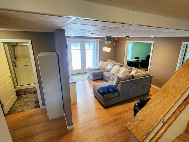 305 Fuller Rd, Easton, ME 04740 - living room with wood finished floors, baseboards, french doors, and a ceiling fan