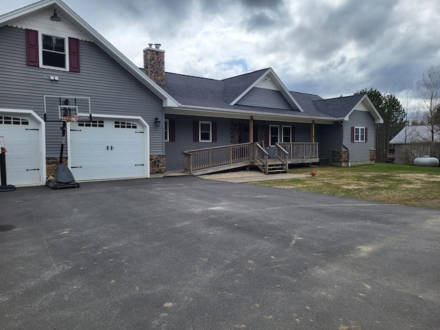 305 Fuller Rd, Easton, ME 04740 - view of front of home featuring a chimney, driveway, and covered porch