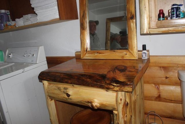 interior space featuring wood walls and washer / dryer