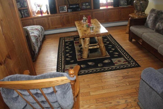 living room with light hardwood / wood-style flooring and a baseboard heating unit