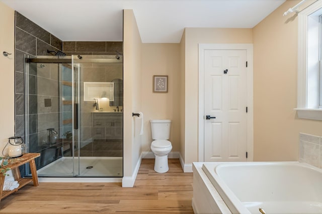 bathroom featuring independent shower and bath, toilet, and hardwood / wood-style floors