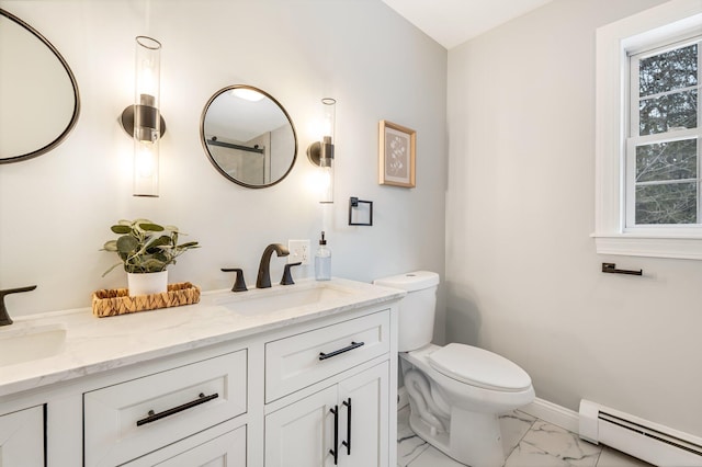 bathroom with a baseboard heating unit, vanity, and a healthy amount of sunlight