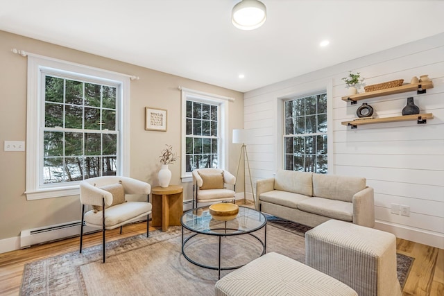 sitting room featuring hardwood / wood-style floors and wood walls