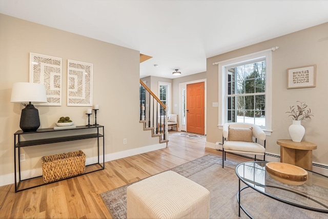 living room with light hardwood / wood-style flooring and a baseboard heating unit