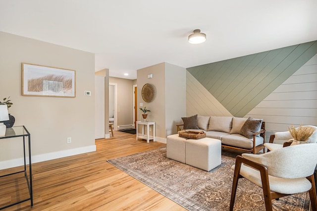 living room featuring wood-type flooring and baseboard heating