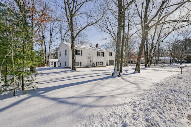 view of snow covered rear of property