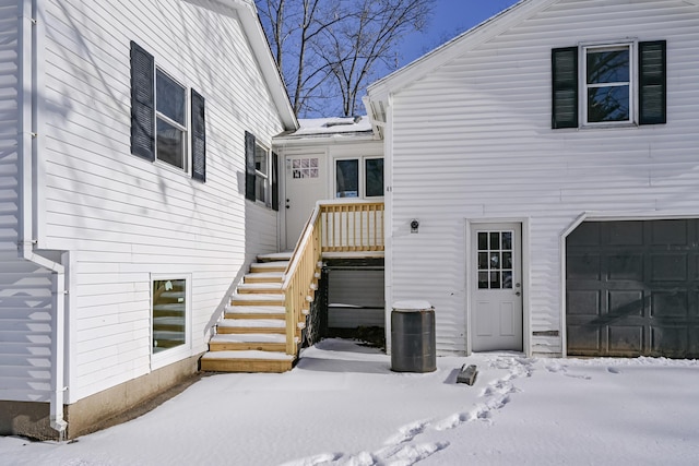 snow covered house with a garage