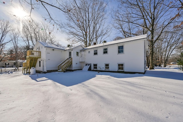 view of snow covered rear of property