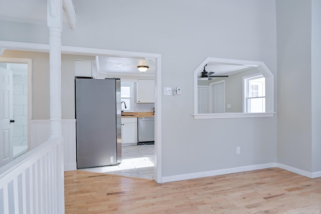 interior space featuring ceiling fan, sink, and light hardwood / wood-style flooring