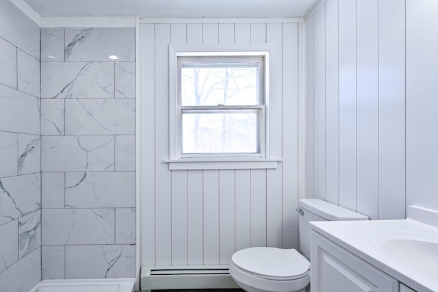 bathroom featuring baseboard heating, vanity, toilet, and a shower