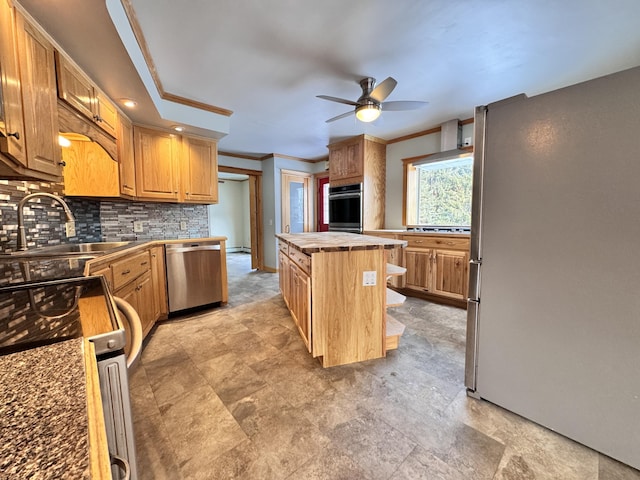 kitchen featuring a center island, tasteful backsplash, appliances with stainless steel finishes, ornamental molding, and a sink