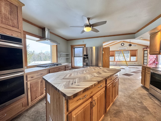 kitchen featuring appliances with stainless steel finishes, ornamental molding, wood counters, and wall chimney exhaust hood