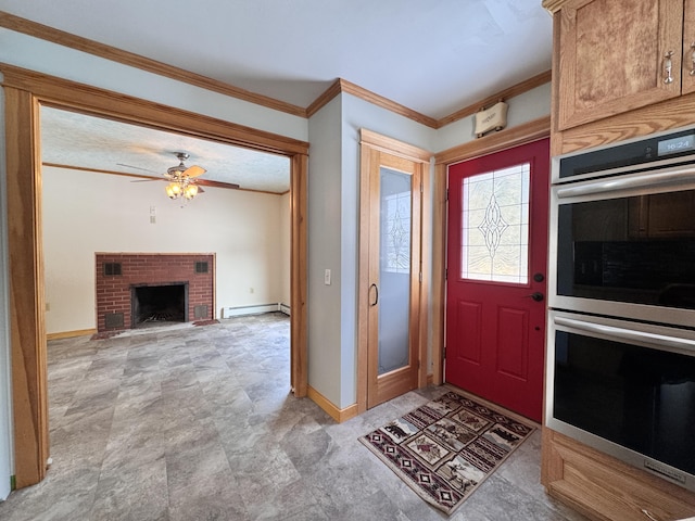 entrance foyer featuring baseboards, a ceiling fan, a baseboard radiator, ornamental molding, and a brick fireplace