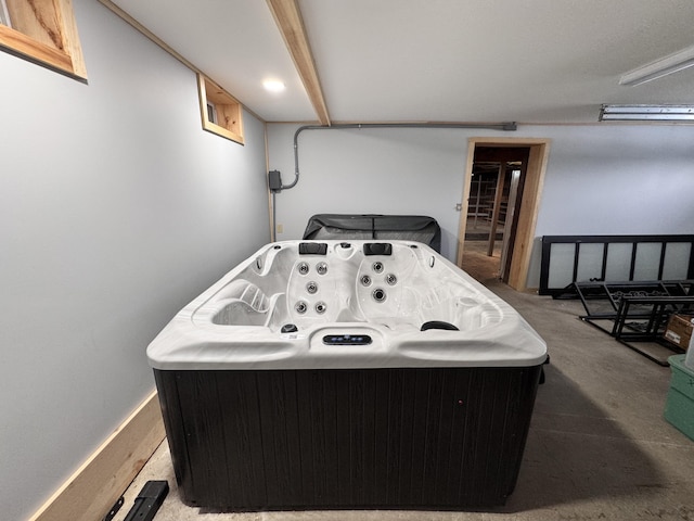 recreation room featuring baseboards and a hot tub