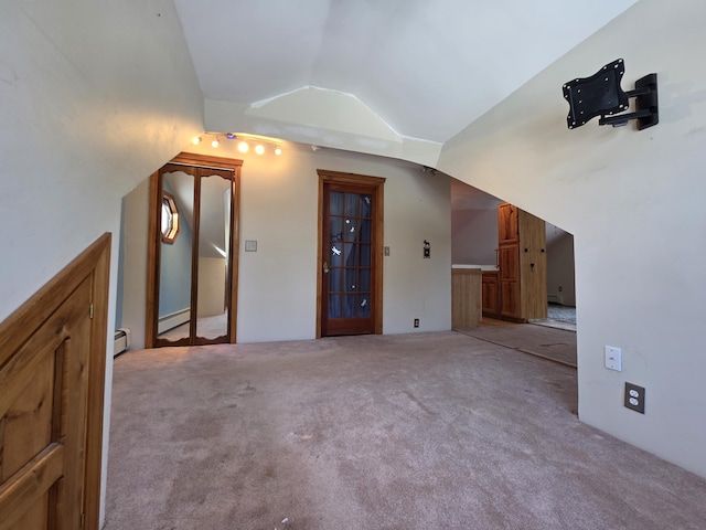 additional living space with carpet floors, vaulted ceiling, and baseboard heating