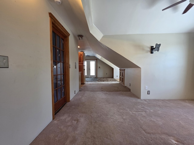 additional living space with vaulted ceiling, carpet flooring, and a ceiling fan