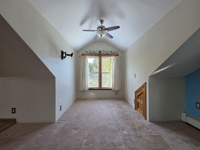 additional living space featuring lofted ceiling, a baseboard heating unit, carpet flooring, and a ceiling fan