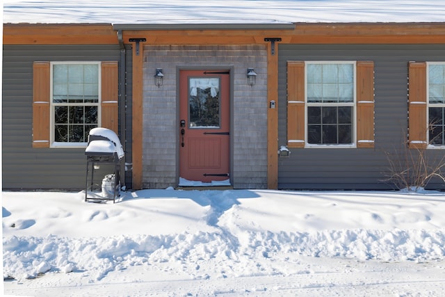 view of snow covered property entrance