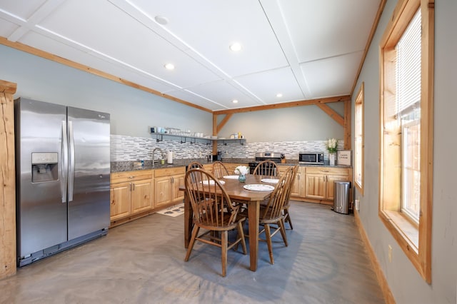 dining room featuring sink and a wealth of natural light