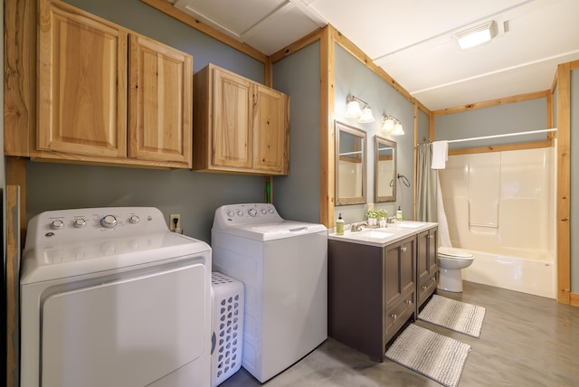 clothes washing area featuring washer and clothes dryer and sink