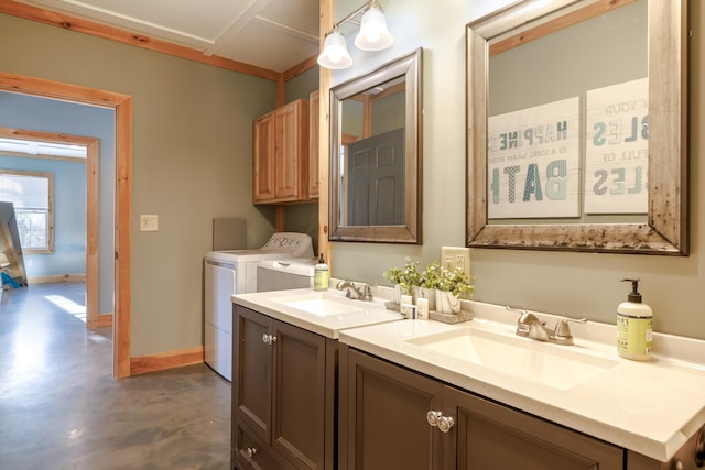 bathroom with vanity, separate washer and dryer, and concrete floors