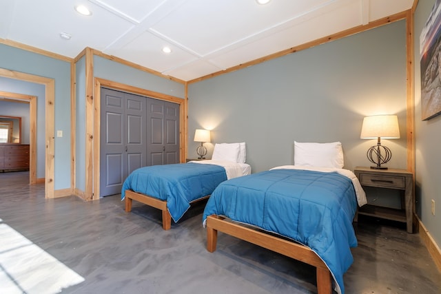 bedroom with coffered ceiling, concrete flooring, and a closet