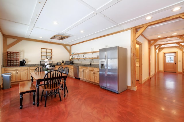 kitchen featuring light brown cabinetry, sink, stainless steel appliances, and dark stone counters