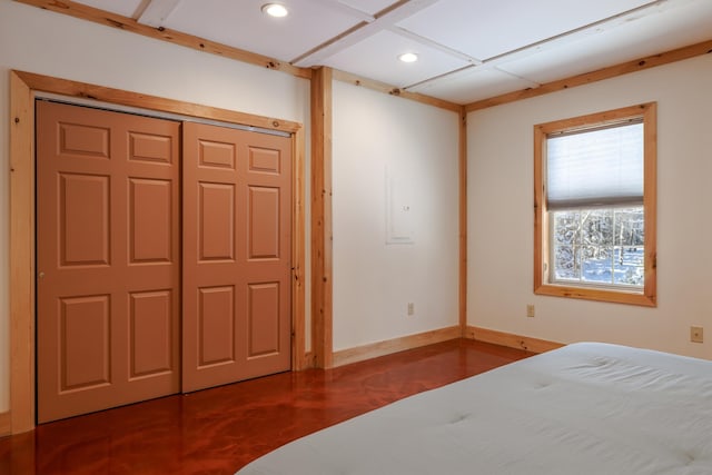 bedroom with electric panel and a closet