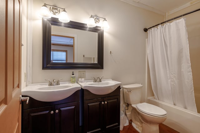 full bathroom featuring vanity, crown molding, shower / bath combo with shower curtain, and toilet