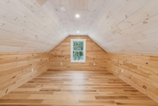 additional living space featuring wood ceiling, lofted ceiling, hardwood / wood-style floors, and wood walls