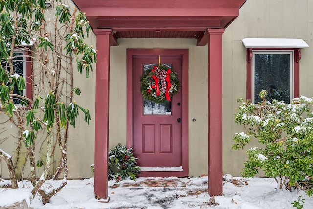 view of snow covered property entrance