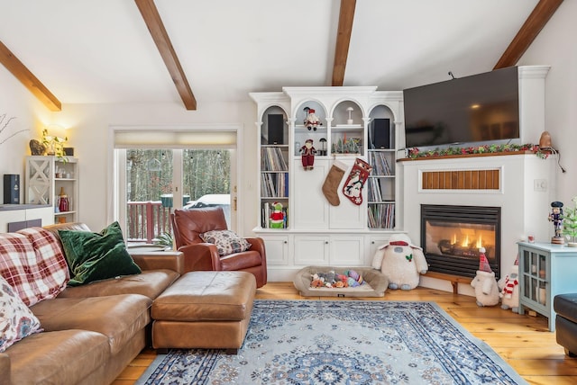 living room featuring light hardwood / wood-style floors and beamed ceiling