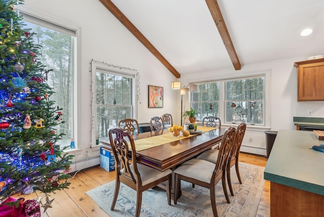 dining area with vaulted ceiling with beams, a baseboard radiator, and light wood-type flooring