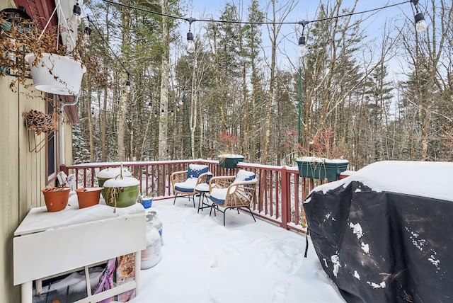 snow covered deck featuring grilling area