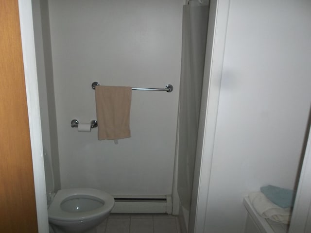 bathroom with tile patterned floors, a baseboard radiator, and toilet