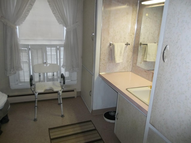 bathroom featuring wallpapered walls, vanity, and a baseboard radiator