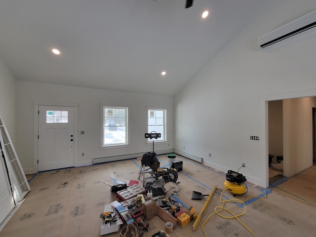 exercise area featuring baseboard heating, high vaulted ceiling, and an AC wall unit