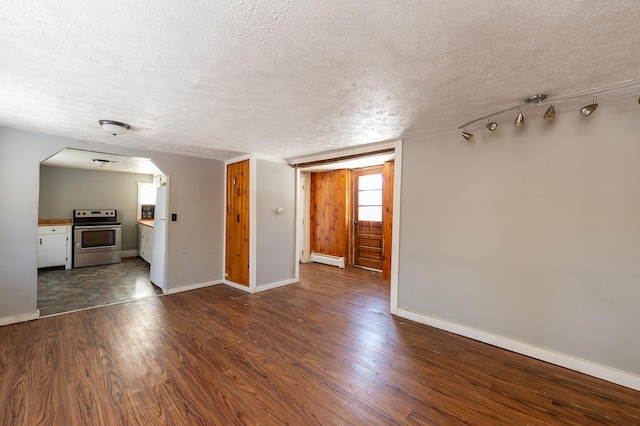 unfurnished living room with dark hardwood / wood-style flooring, a textured ceiling, and a baseboard heating unit