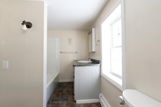 full bathroom featuring vanity, a baseboard heating unit, toilet, and shower / bath combination