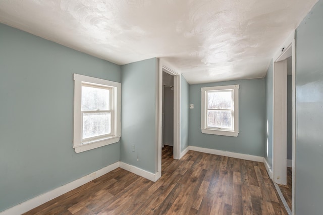 unfurnished bedroom featuring dark wood-type flooring