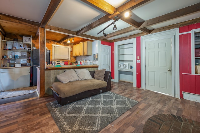 living room featuring dark wood-type flooring, built in features, and beamed ceiling