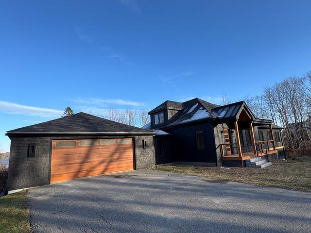 view of front of property featuring a garage and covered porch