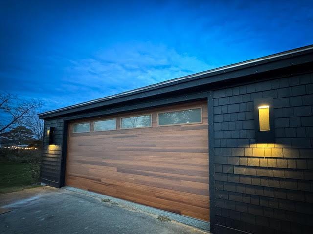 view of garage at dusk