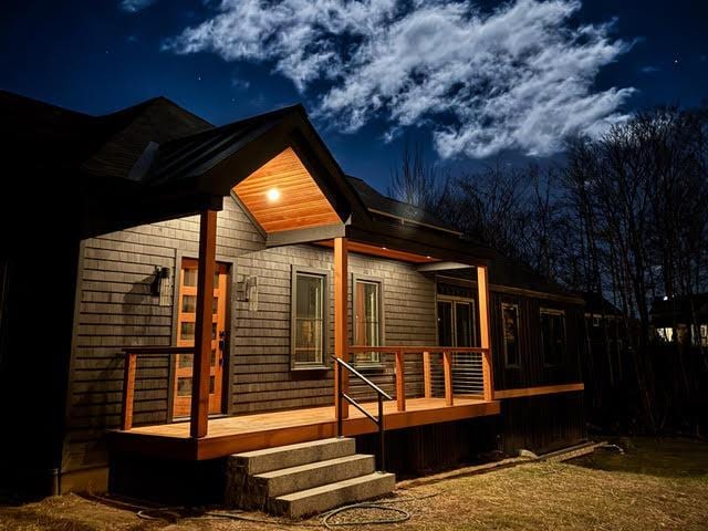 rear view of property featuring a wooden deck